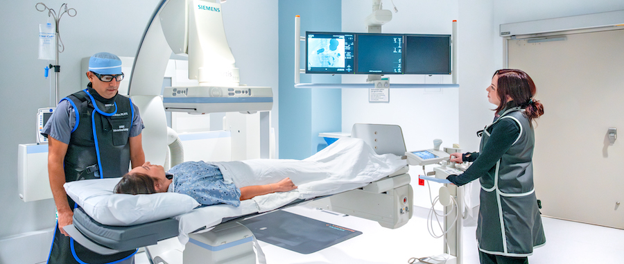 A radiology technician speaking to a patient